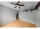 Neutral bedroom with wood floors, a ceiling fan, and a unique wood display shelf at 1413 Brookebridge Dr, Orlando, FL 32825