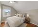 A cozy bedroom featuring a neutral color palette, a window with a view, and stylish nightstands with lamps at 1413 Brookebridge Dr, Orlando, FL 32825