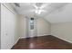 This bedroom features wood floors, a ceiling fan, a double-door closet and natural lighting at 1413 Brookebridge Dr, Orlando, FL 32825