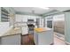 Well-lit kitchen features stainless steel appliances, granite countertops, white cabinets, and a kitchen island at 1413 Brookebridge Dr, Orlando, FL 32825