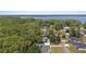 Stunning aerial view of homes near a lake and surrounded by lush green trees at 14612 Bray Rd, Orlando, FL 32832