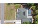 Aerial view of a green roof, a screened-in pool and a long driveway at 14612 Bray Rd, Orlando, FL 32832