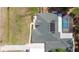 Aerial view of a home with green roof, screened-in pool and extra space on property at 14612 Bray Rd, Orlando, FL 32832