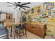 Entertain in this awesome bar area featuring custom wood cabinets and checkerboard table at 14612 Bray Rd, Orlando, FL 32832