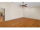 Spacious bedroom showcasing beautiful hardwood floors, ceiling fan, and neutral wall color at 14612 Bray Rd, Orlando, FL 32832