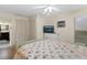 Cozy bedroom features wood floors, ceiling fan, and an ensuite bathroom, with TV at 14612 Bray Rd, Orlando, FL 32832
