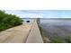 Long wooden dock with a gazebo stretches out into the lake, inviting leisurely strolls at 14612 Bray Rd, Orlando, FL 32832