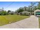 Well maintained lawn with a long drive leading to the detached garage at 14612 Bray Rd, Orlando, FL 32832