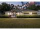 Inviting single-story home featuring arched windows, brick accents, and a well-manicured lawn at 14612 Bray Rd, Orlando, FL 32832