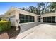 Detached garage with screen doors and adjacent mulched garden at 14612 Bray Rd, Orlando, FL 32832