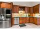 Kitchen showcases stainless steel appliances, custom wood cabinets, and tile backsplash at 14612 Bray Rd, Orlando, FL 32832