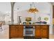 Kitchen island with oven and bar seating that opens into the living room at 14612 Bray Rd, Orlando, FL 32832