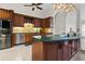 Kitchen featuring custom wood cabinets, a large island, and stainless steel appliances at 14612 Bray Rd, Orlando, FL 32832