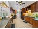 Well-equipped kitchen with custom wood cabinets, stainless steel appliances, and elegant lighting at 14612 Bray Rd, Orlando, FL 32832