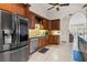 Kitchen boasts stainless steel appliances, custom wood cabinetry, and tile flooring at 14612 Bray Rd, Orlando, FL 32832