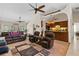 Spacious living room featuring vaulted ceilings, ceiling fans and access to the kitchen with decorative tile flooring at 14612 Bray Rd, Orlando, FL 32832
