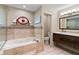Main bathroom featuring a soaking tub, walk-in shower, decorative tile, and stained glass at 14612 Bray Rd, Orlando, FL 32832