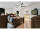 Main bedroom featuring wood floors, ceiling fan, recessed lights and an arched entrance to the bathroom at 14612 Bray Rd, Orlando, FL 32832