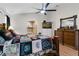 Main bedroom features tile floors, ceiling fan, and an arched entrance to the bathroom at 14612 Bray Rd, Orlando, FL 32832