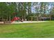 Community playground features swings, slides, and climbing structures set in a grassy park area at 14612 Bray Rd, Orlando, FL 32832