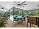 Large screened-in pool with seating areas, a bar, and lush green surroundings at 14612 Bray Rd, Orlando, FL 32832