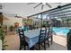 Screened-in pool area with multiple seating areas, an outdoor kitchen, and a tropical backyard at 14612 Bray Rd, Orlando, FL 32832