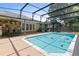 Beautiful screened-in pool area with outdoor kitchen, bar seating, and cozy lounge area at 14612 Bray Rd, Orlando, FL 32832