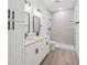 Modern bathroom featuring a double vanity, white countertops, and a tiled walk-in shower at 14930 Sw 66Th Ave Rd, Ocala, FL 34473