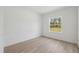 Bright bedroom features a window bringing in natural light and light wood-look flooring at 14930 Sw 66Th Ave Rd, Ocala, FL 34473