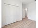 Bedroom featuring a bi-fold closet and light-colored flooring, with doorways leading to other rooms at 14930 Sw 66Th Ave Rd, Ocala, FL 34473