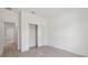 Bedroom featuring a closet and light-colored flooring, with doorways leading to other rooms at 14930 Sw 66Th Ave Rd, Ocala, FL 34473