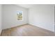 Cozy bedroom with a window showcasing natural light and light wood-look floors at 14930 Sw 66Th Ave Rd, Ocala, FL 34473