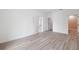 A spacious bedroom with light-colored flooring, white walls, and multiple doorways at 14930 Sw 66Th Ave Rd, Ocala, FL 34473
