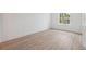 A bright bedroom with a large window providing natural light and wood-look flooring at 14930 Sw 66Th Ave Rd, Ocala, FL 34473