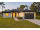 Charming single-story home with a well-maintained lawn, neutral stucco, and an attached two-car garage at 14930 Sw 66Th Ave Rd, Ocala, FL 34473
