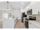 A bright kitchen featuring black stainless steel appliances and quartz countertops at 14930 Sw 66Th Ave Rd, Ocala, FL 34473