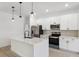 Modern kitchen with stainless steel appliances, quartz countertops, and sleek white cabinets at 14930 Sw 66Th Ave Rd, Ocala, FL 34473