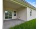 A covered patio provides a great view with a sliding glass door, and a grassy lawn at 14930 Sw 66Th Ave Rd, Ocala, FL 34473
