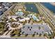 Community aerial view showcases various pools, a clubhouse, parking, and manicured landscaping at 1505 Nassau Point Trl, Kissimmee, FL 34747