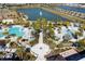 Aerial view of a resort with a fountain pond, pools, walking paths, cabanas, and lush landscaping at 1505 Nassau Point Trl, Kissimmee, FL 34747
