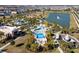 Community aerial view featuring pools, a playground, and community amenities by a tranquil lake at 1505 Nassau Point Trl, Kissimmee, FL 34747
