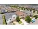 Aerial view of the property nestled in a vibrant neighborhood with well-maintained landscaping and convenient street access at 1505 Nassau Point Trl, Kissimmee, FL 34747