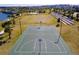 Aerial view of a basketball court, soccer field, and lake in a manicured common area, ideal for outdoor activity at 1505 Nassau Point Trl, Kissimmee, FL 34747