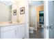 Comfortable bathroom featuring a vanity and toilet next to bedroom access at 1505 Nassau Point Trl, Kissimmee, FL 34747