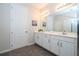 Bright bathroom features double vanity, white cabinets, and sleek gray tile floors at 1505 Nassau Point Trl, Kissimmee, FL 34747