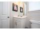 Cozy bathroom with a vanity, framed print, and a convenient toilet setup at 1505 Nassau Point Trl, Kissimmee, FL 34747