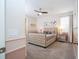 Charming bedroom with a tufted headboard, ensuite bathroom, and neutral color scheme at 1505 Nassau Point Trl, Kissimmee, FL 34747