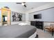 Comfortable bedroom with gray comforter, flat screen tv, and unique wall art creating a relaxing atmosphere at 1505 Nassau Point Trl, Kissimmee, FL 34747