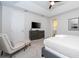 Spacious bedroom with a TV, ensuite bathroom, seating area, and ample natural light at 1505 Nassau Point Trl, Kissimmee, FL 34747