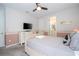 Comfortable bedroom with a TV, ensuite bathroom, and soft, neutral color scheme at 1505 Nassau Point Trl, Kissimmee, FL 34747